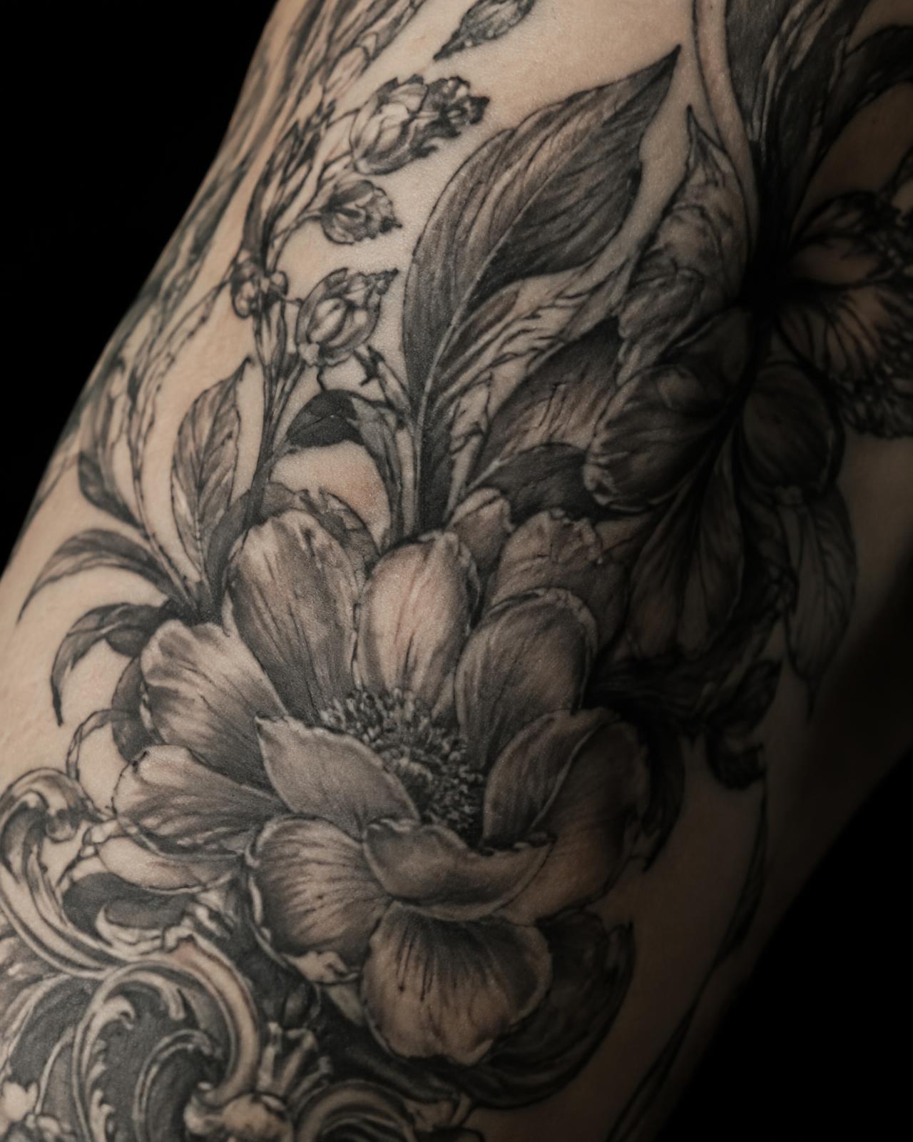 Detailed black and grey tattoo work